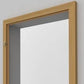 A light natural wood door frame with a white panel insert, shown against a plain light gray background.