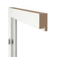 A close-up of a white-framed door or window header with a light brown wood trim piece, shown against a plain white background.