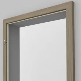 A light oak wood interior door frame with a white door installed, shown against a plain light gray wall.