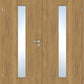 A pair of light oak double doors with two vertical rectangular glass panes in the center of each door and a silver metal handle.