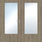 Double wooden doors with light oak grain and frosted rectangular glass panels, featuring a silver metal handle and lock on the left door.