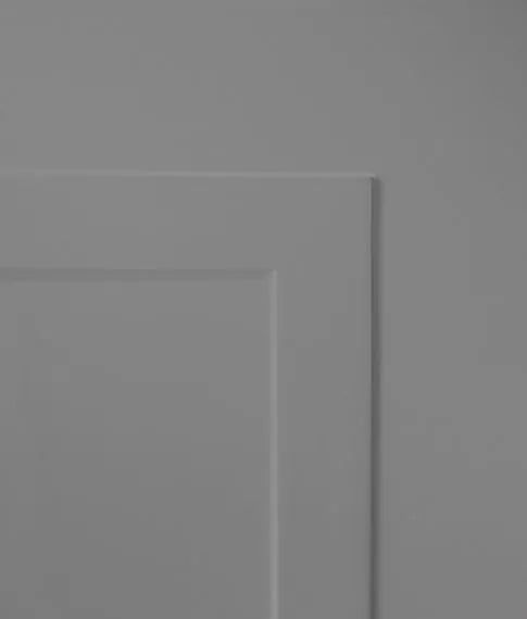 Close-up of a gray door with a rectangular panel