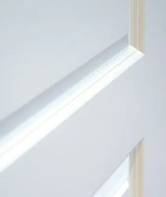 Close-up of a white paneled door with a light beige frame edge visible along the top and bottom.