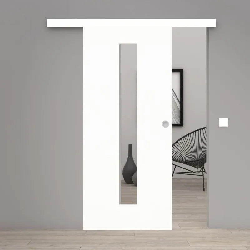 A modern white sliding door with a vertical rectangular glass panel, shown installed in a minimalist gray interior room with light wood flooring.