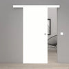 A modern white sliding door with a minimalist metal doorknob, shown partially open in a minimalist gray room with light wood flooring.