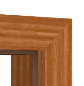 Close-up of a wood-framed doorway corner showing the warm medium-brown grain and layered molding profile against a white background.