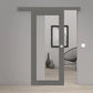 Gray sliding glass door installed in a modern gray interior doorway, with a light wood floor and a black wire chair visible in the room behind it.