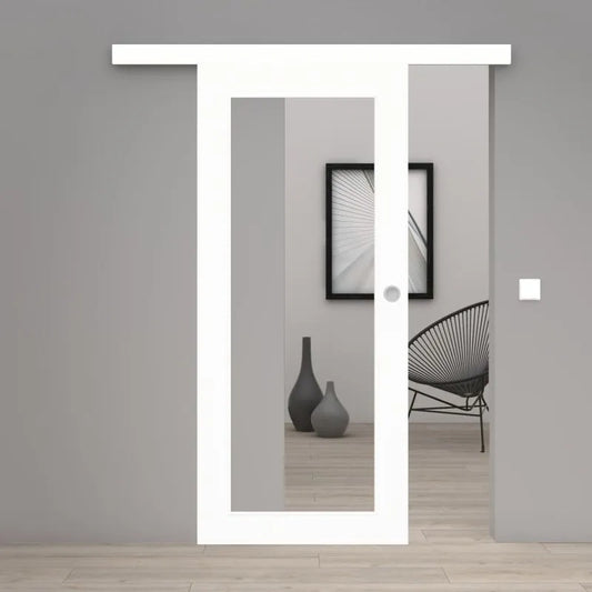 A modern white sliding door frame installed in a minimalist gray interior room with light wood flooring, a black wire chair, and a framed black-and-white wall art piece.